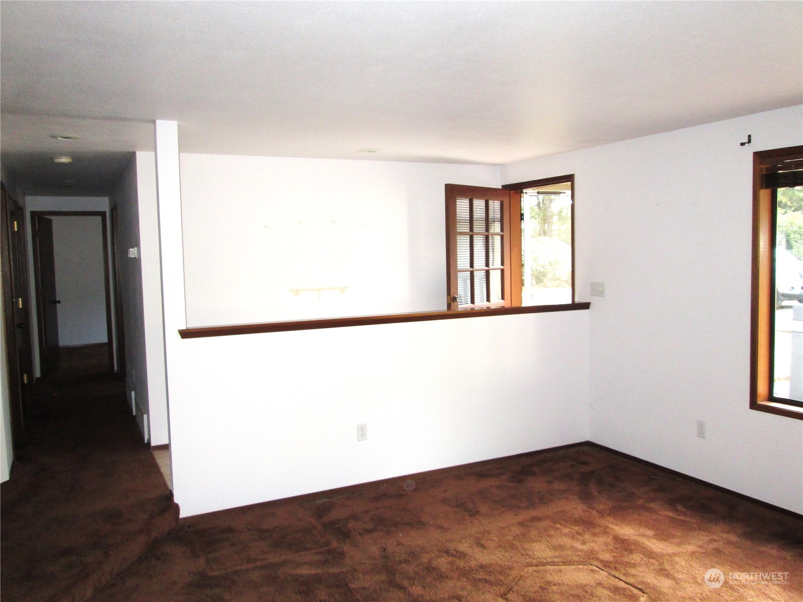 15 Webb Road Southwest Lakebay, WA 98349 - Photo 5 of 39 an empty room with wooden floor and windows