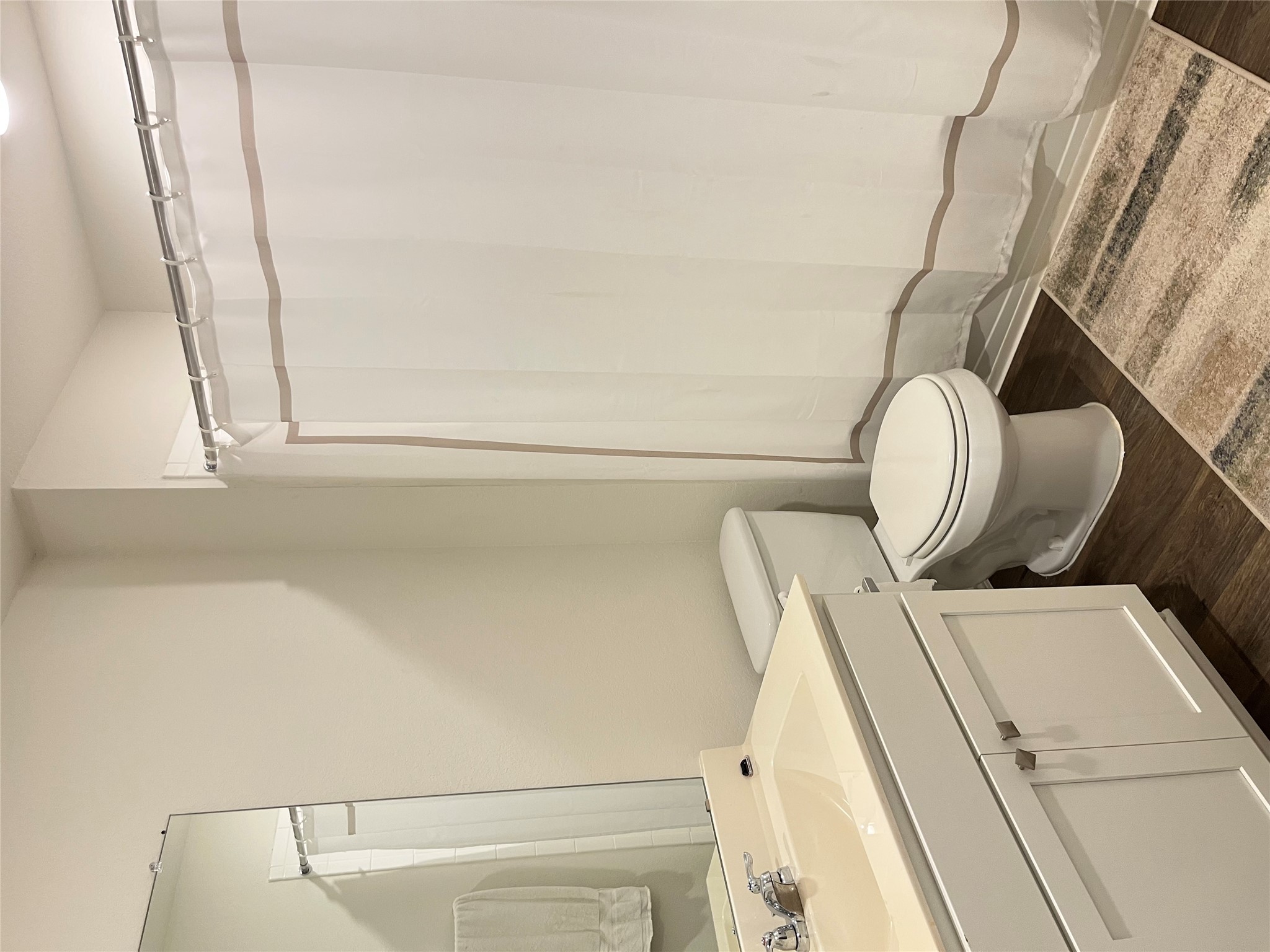 12313 Token Trail Elgin, TX 78621 - Photo 13 of 15 Full bathroom featuring a white vanity with integrated sink, white toilet, and tub/shower combination