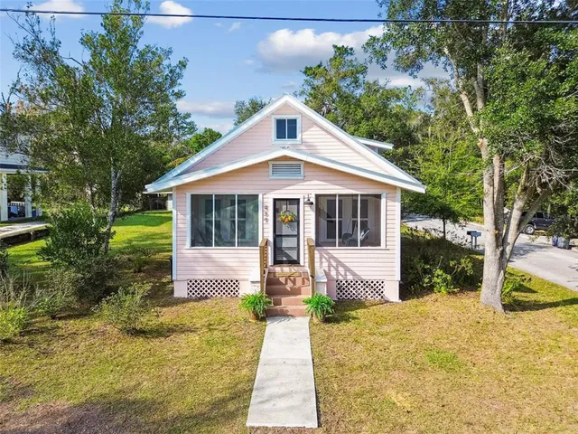 a front view of house with yard and green space
