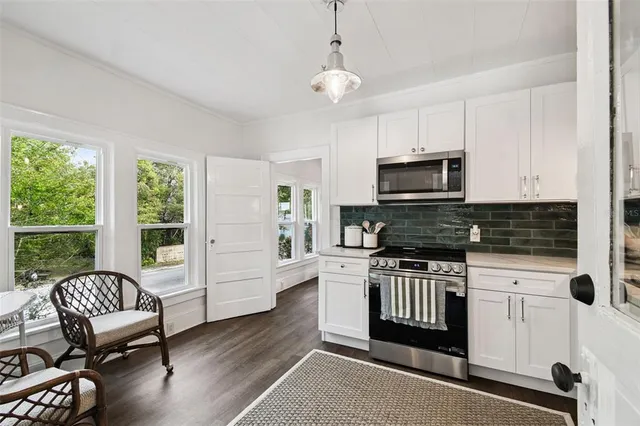 a kitchen with a stove a sink and a microwave