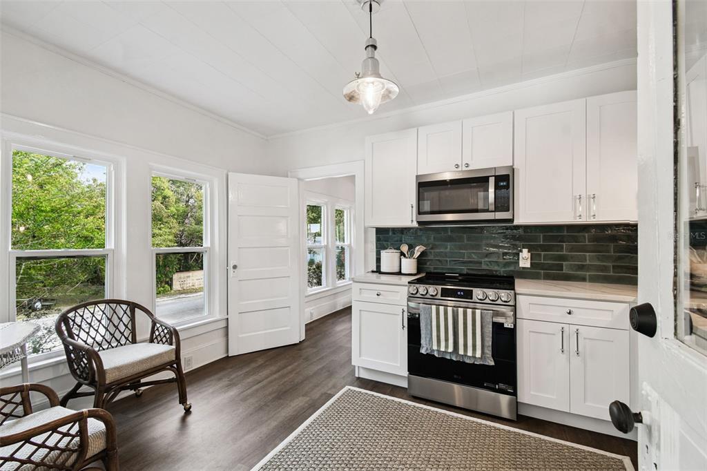 459 Bell Avenue Brooksville, FL 34601 - Photo 12 of 36 a kitchen with a stove a sink and a microwave
