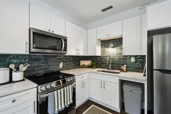 a kitchen with a sink stove and microwave