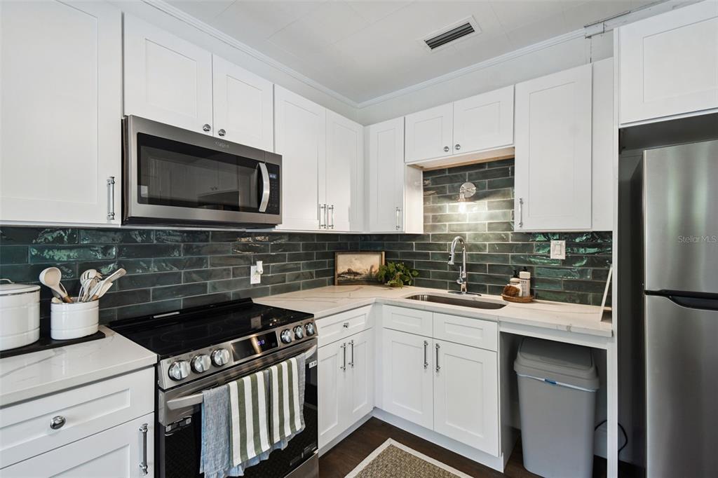 459 Bell Avenue Brooksville, FL 34601 - Photo 16 of 36 a kitchen with a sink stove and microwave