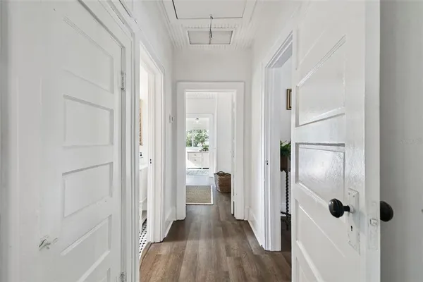 a view of a hallway with wooden floor and closet area
