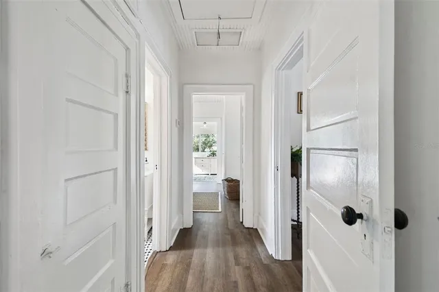 a view of a hallway with wooden floor and closet area