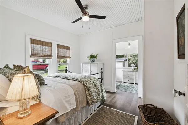 a bedroom with a bed and wooden floor