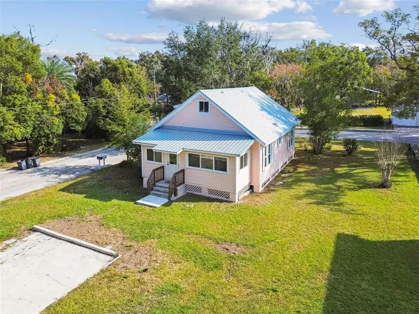 a view of a house with pool and sitting area