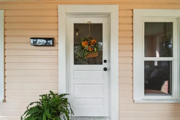 a view of a door of a house with potted plants