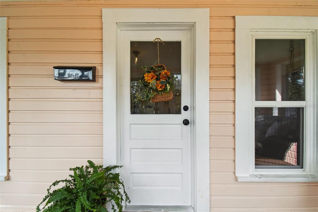 459 Bell Avenue Brooksville, FL 34601 - Photo 4 of 36 a view of a door of a house with potted plants