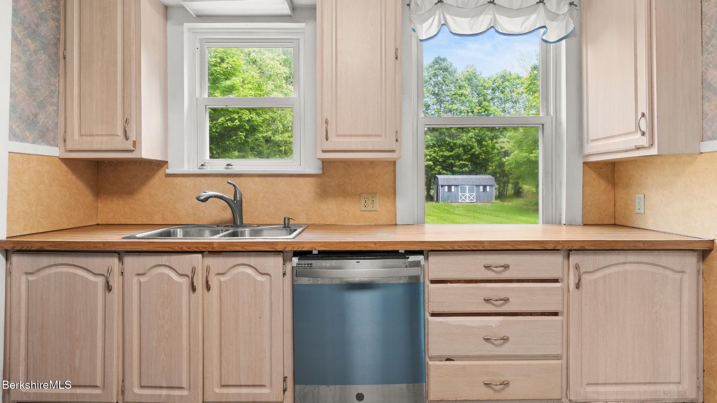 349 New Lenox Road Lenox, MA 01240 - Photo 11 of 22 a kitchen with white cabinets and a window