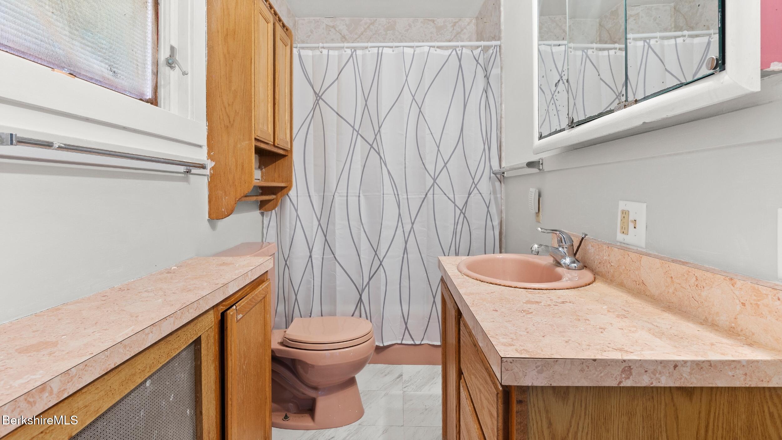 349 New Lenox Road Lenox, MA 01240 - Photo 16 of 22 a bathroom with a sink a toilet and shower curtain
