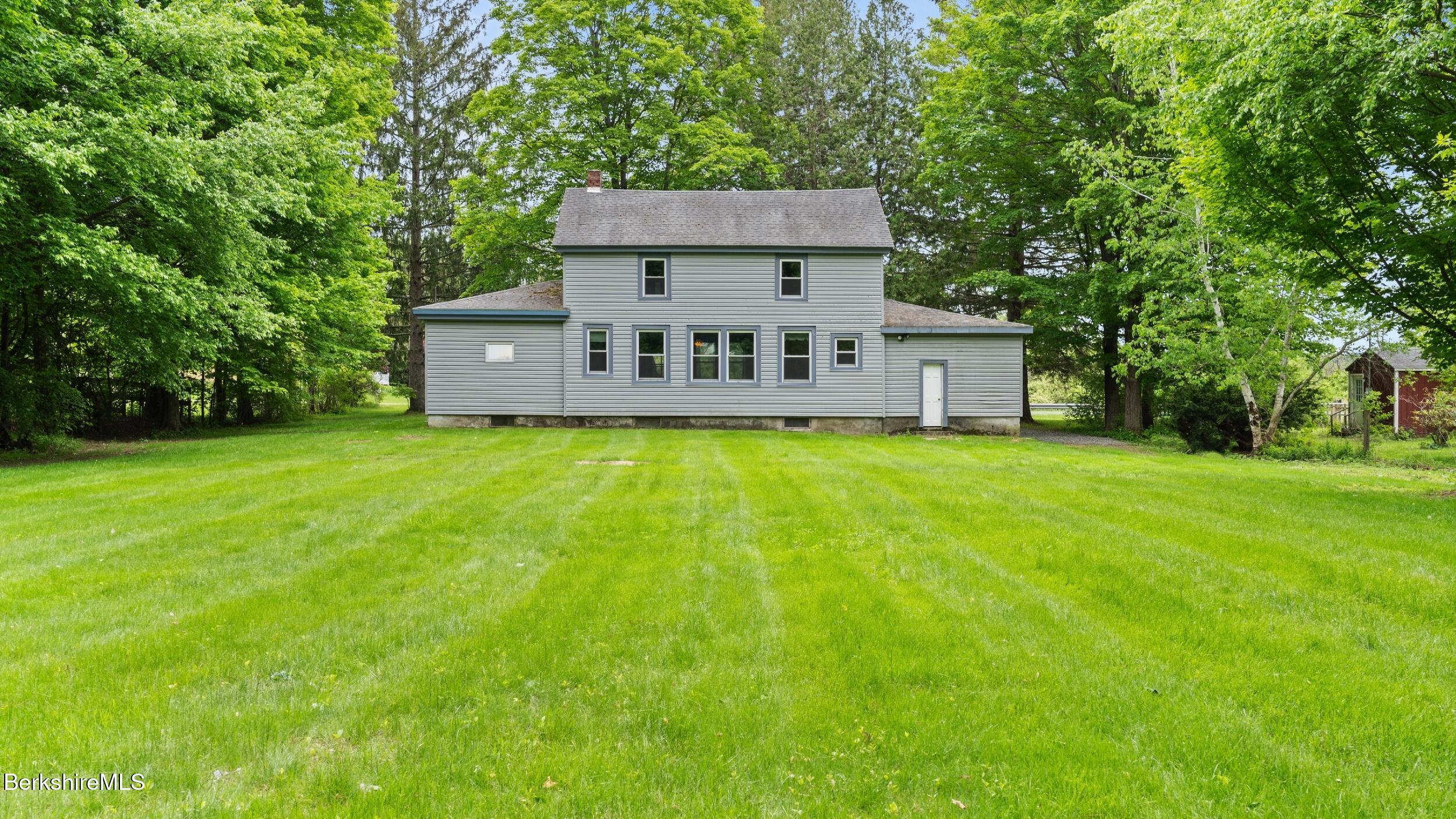 349 New Lenox Road Lenox, MA 01240 - Photo 6 of 22 a view of a house with a big yard and a large tree