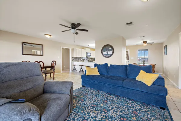 a kitchen with stainless steel appliances granite countertop a sink a stove and a refrigerator with wooden floor