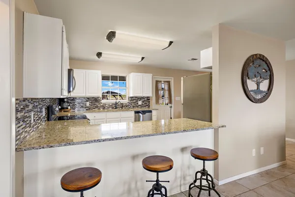 a kitchen with stainless steel appliances granite countertop a sink and a stove
