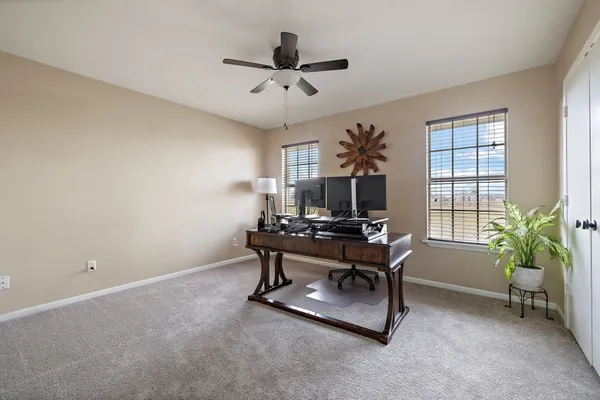 a spacious bedroom with a bed and a window