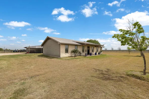 a view of swimming pool with a table and chairs in patio