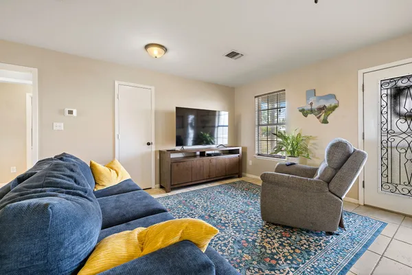 a living room with furniture wooden floor and window