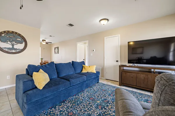 a kitchen with cabinets and chairs