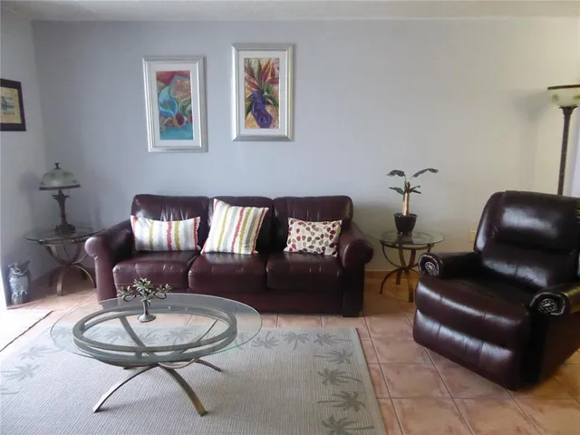 a living room with furniture and a mirror