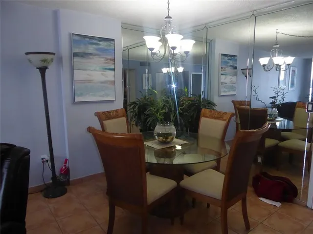 a dining room with furniture and chandelier