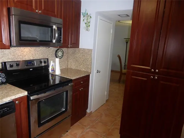 a kitchen with a stove microwave and sink