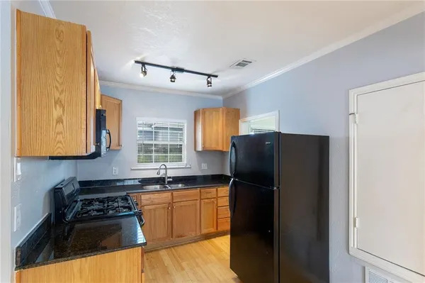 a kitchen with a refrigerator and a sink