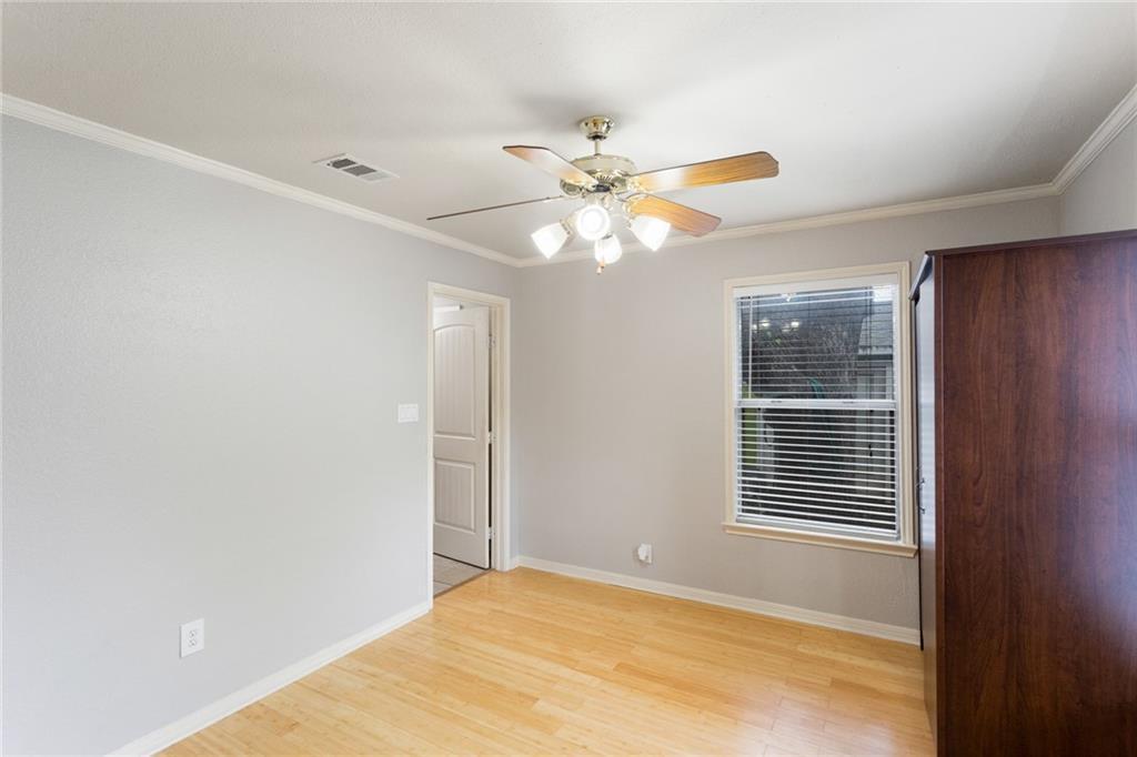74 Julius Street Austin, TX 78702 - Photo 4 of 11 a view of an empty room with chandelier fan and a window