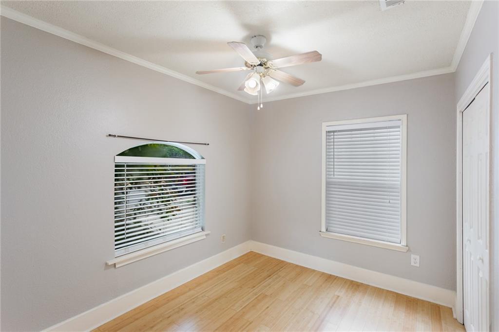 74 Julius Street Austin, TX 78702 - Photo 6 of 11 a view of an empty room with a window and wooden floor