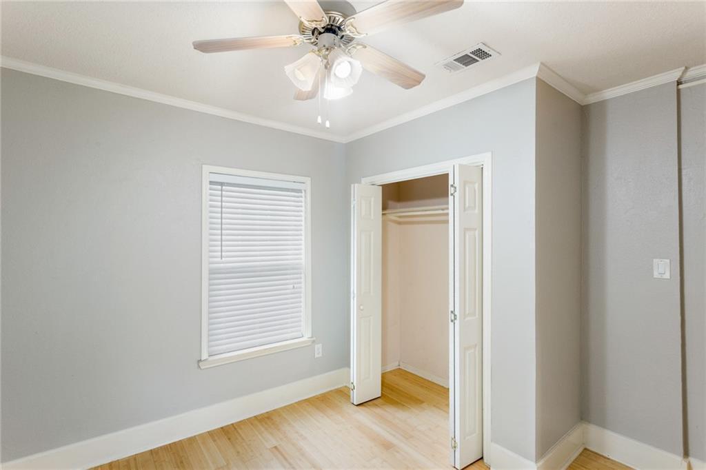 74 Julius Street Austin, TX 78702 - Photo 7 of 11 a view of an empty room with wooden floor and a window
