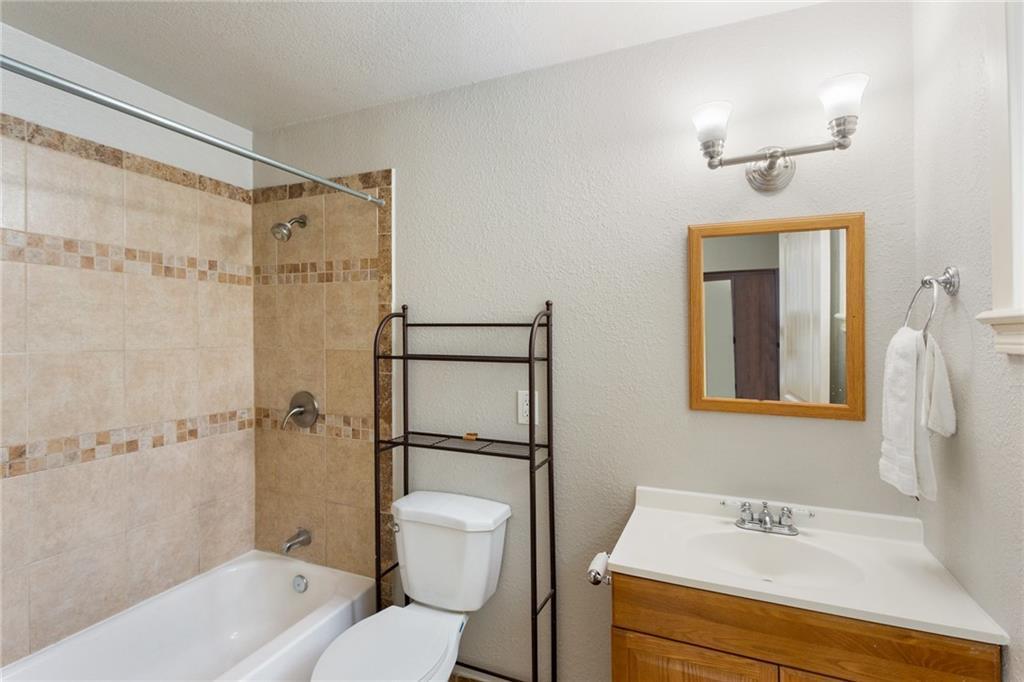 74 Julius Street Austin, TX 78702 - Photo 8 of 11 a bathroom with a sink toilet and shower