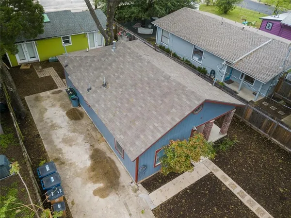 an aerial view of a house with a yard