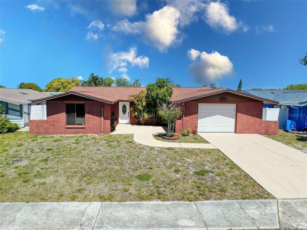 7325 Robstown Drive Port Richey, FL 34668 - Photo 1 of 1 a front view of a house with a yard