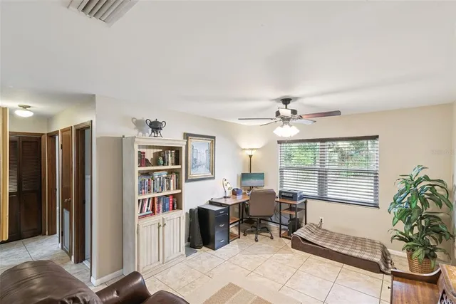 a view of a livingroom with workspace and a window