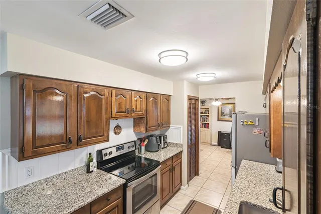 a kitchen with stainless steel appliances granite countertop a stove and a refrigerator