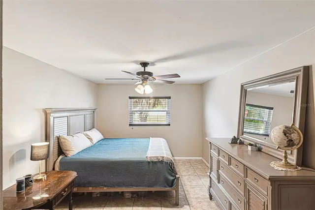 a bedroom with a bed and a dresser with mirror