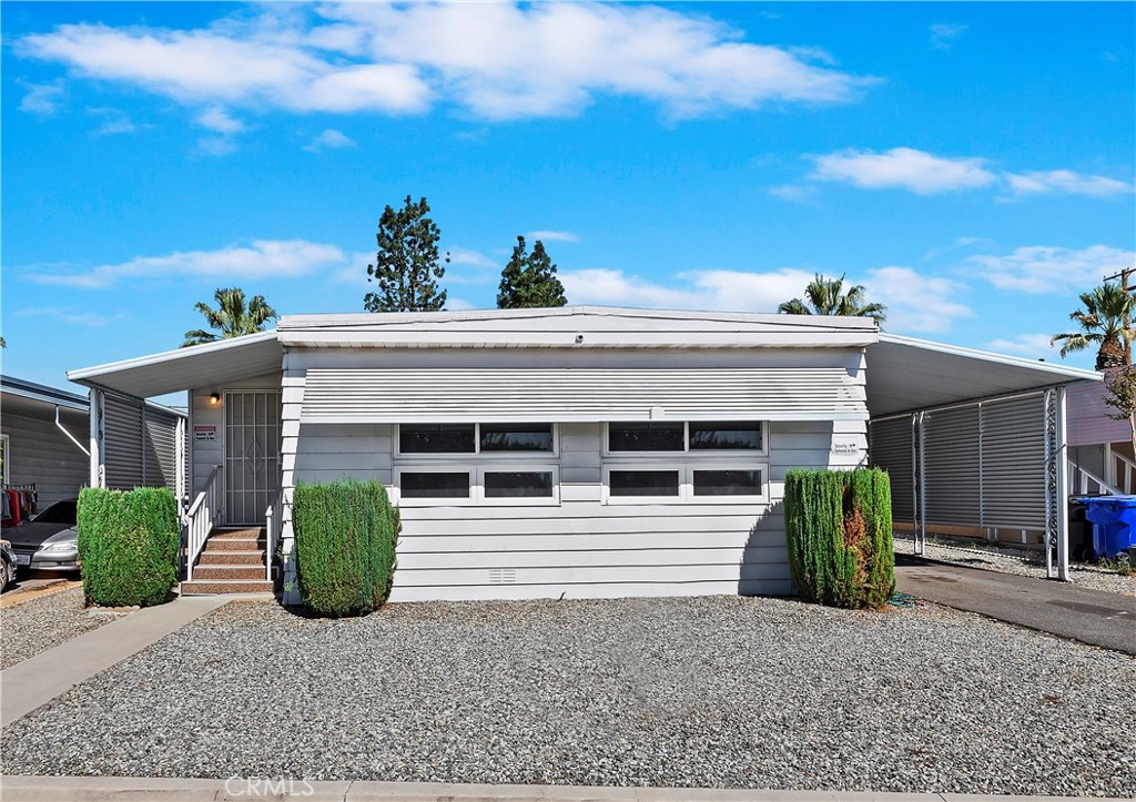 a view of a house with a potted plant and a garage