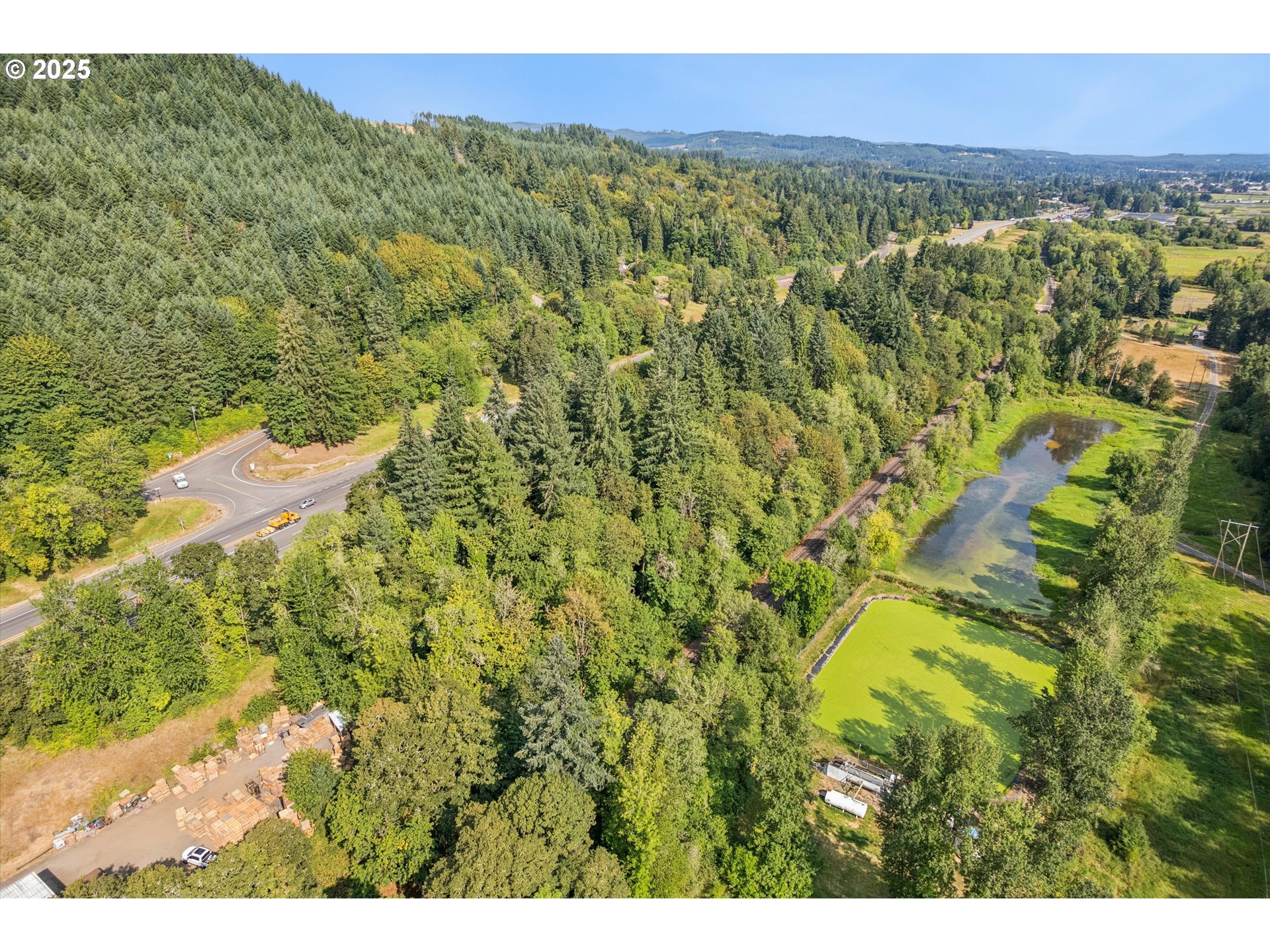25900 Northwest St Helens Road Scappoose, OR 97056 - Photo 19 of 29 a view of a city with lush green forest