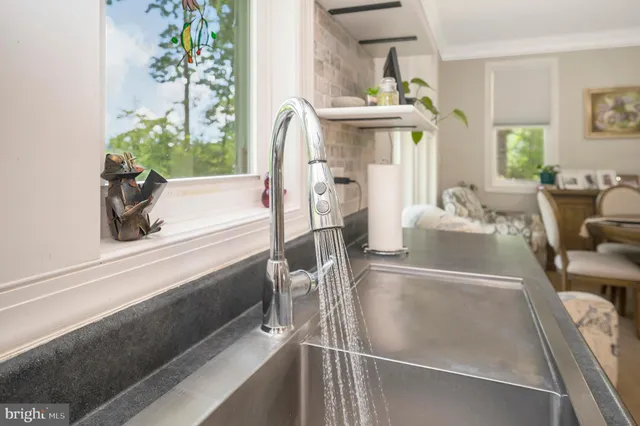 a bedroom with a bed chandelier and a dresser