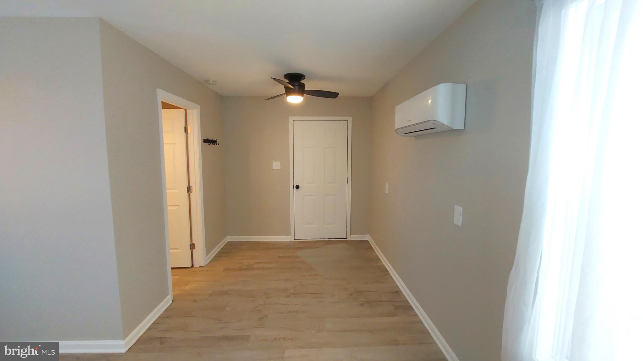 29288 Old Rhoadesville, VA 22542 - Photo 32 of 63 a view of a hallway with wooden floor and a bathroom