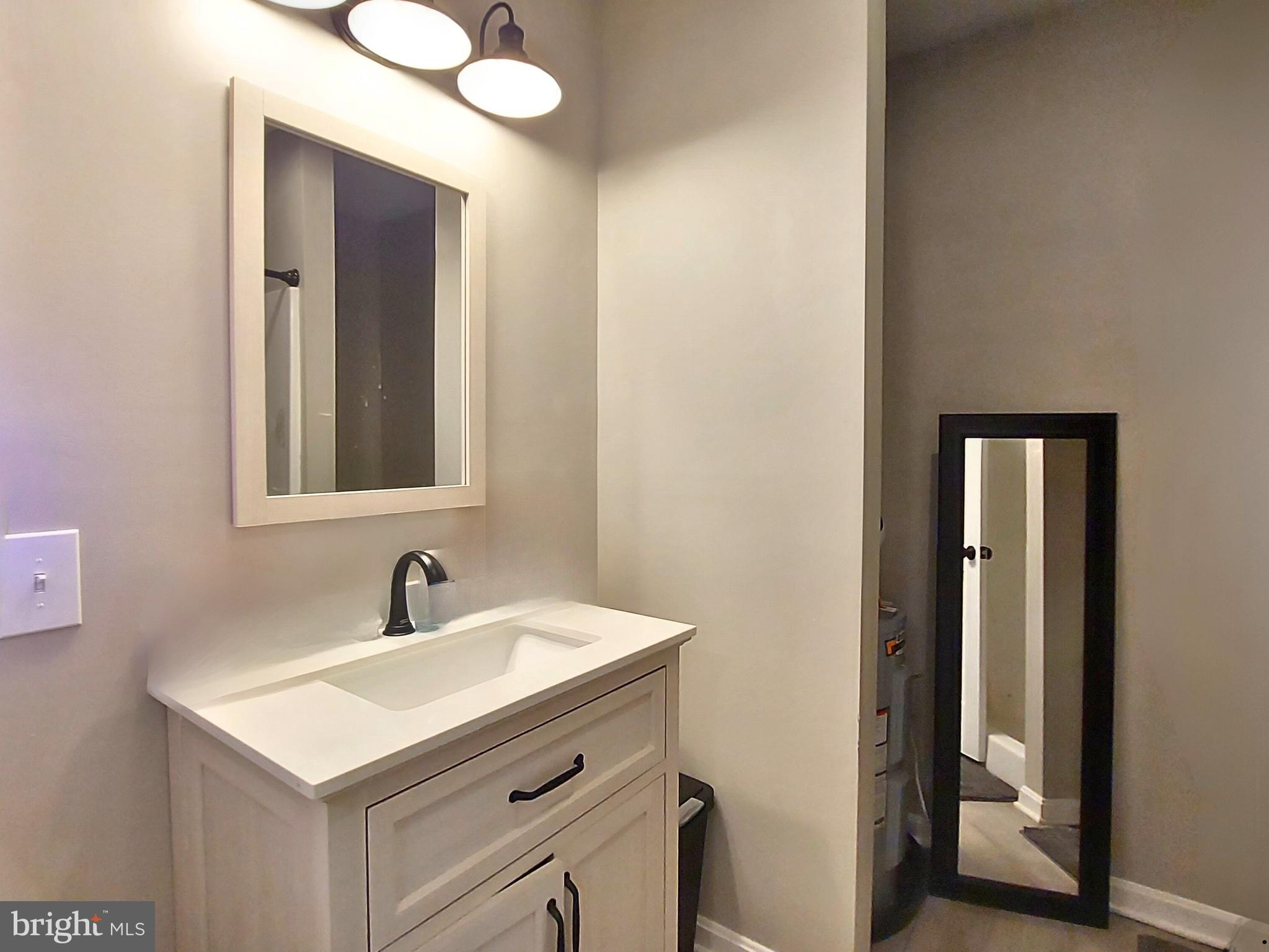 29288 Old Rhoadesville, VA 22542 - Photo 38 of 63 a bathroom with a sink vanity and mirror