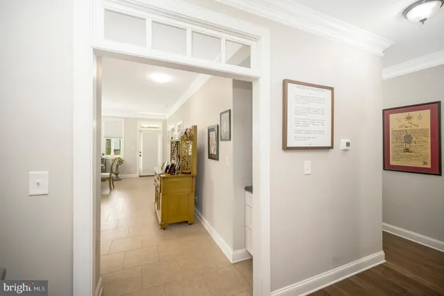 a living room with furniture two window and a kitchen