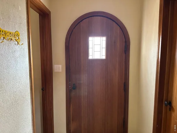 a view of front door with a hallway