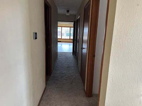 a view of a hallway with a wooden door