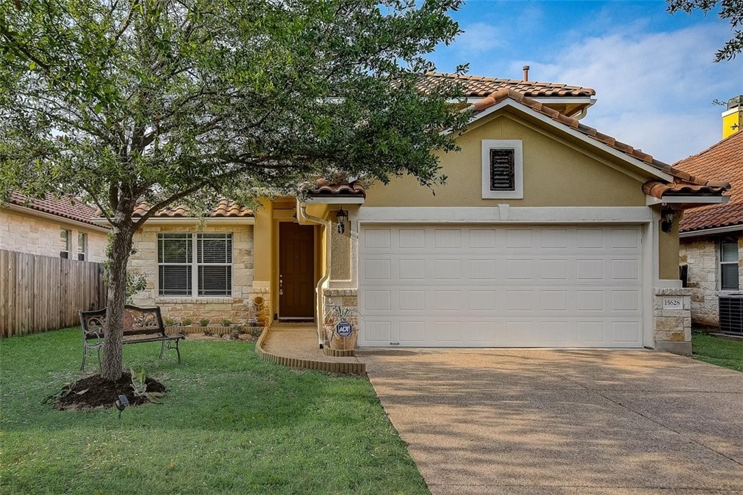 a view of a backyard with furniture potted plants and a large tree