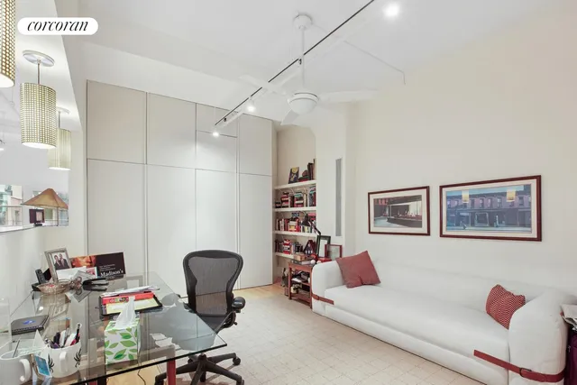 a room with furniture cabinets and a potted plant