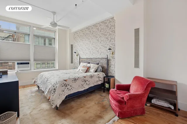 a bedroom with furniture and a chair