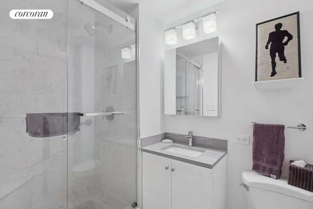 a bedroom with a bed chair and flowerpot