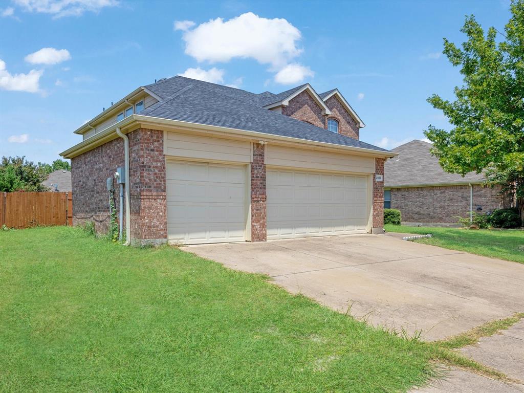 2009 Cooper Ridge Lane Heartland, TX 75126 - Photo 4 of 40 a front view of a house with a yard and garage