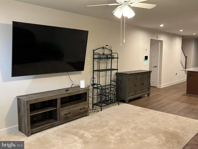 a living room with a flat screen tv and a fireplace