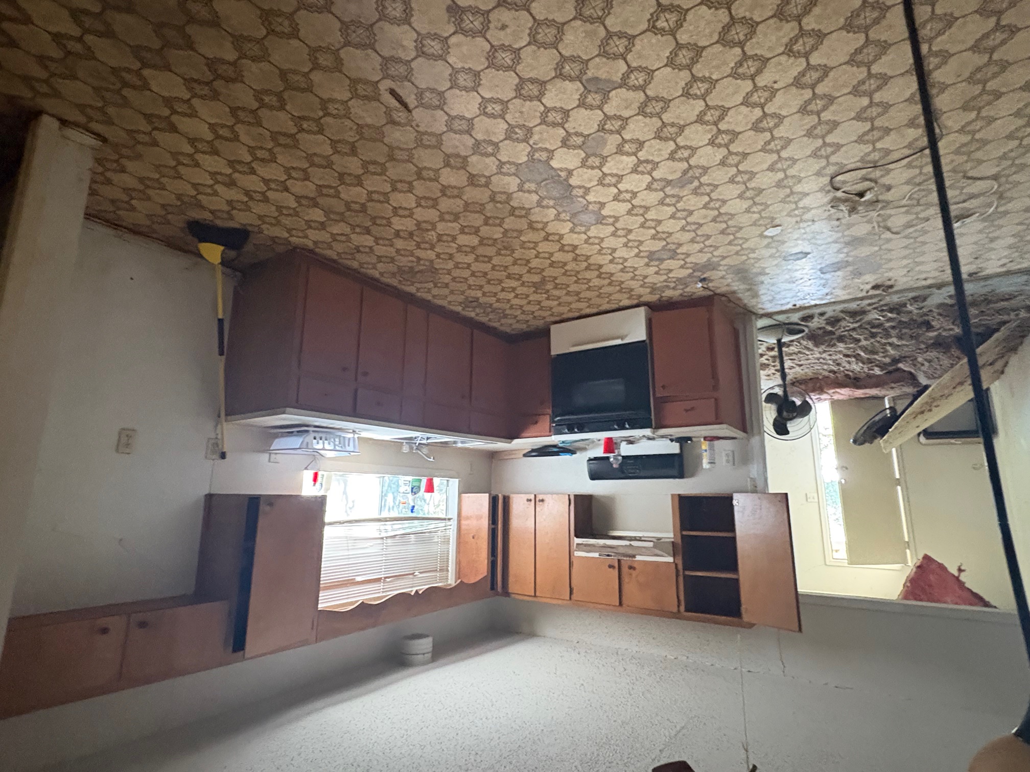 1400 Vargas Road Austin, TX 78741 - Photo 11 of 14 Kitchen with gas range gas stove, light countertops, light floors, and a textured ceiling